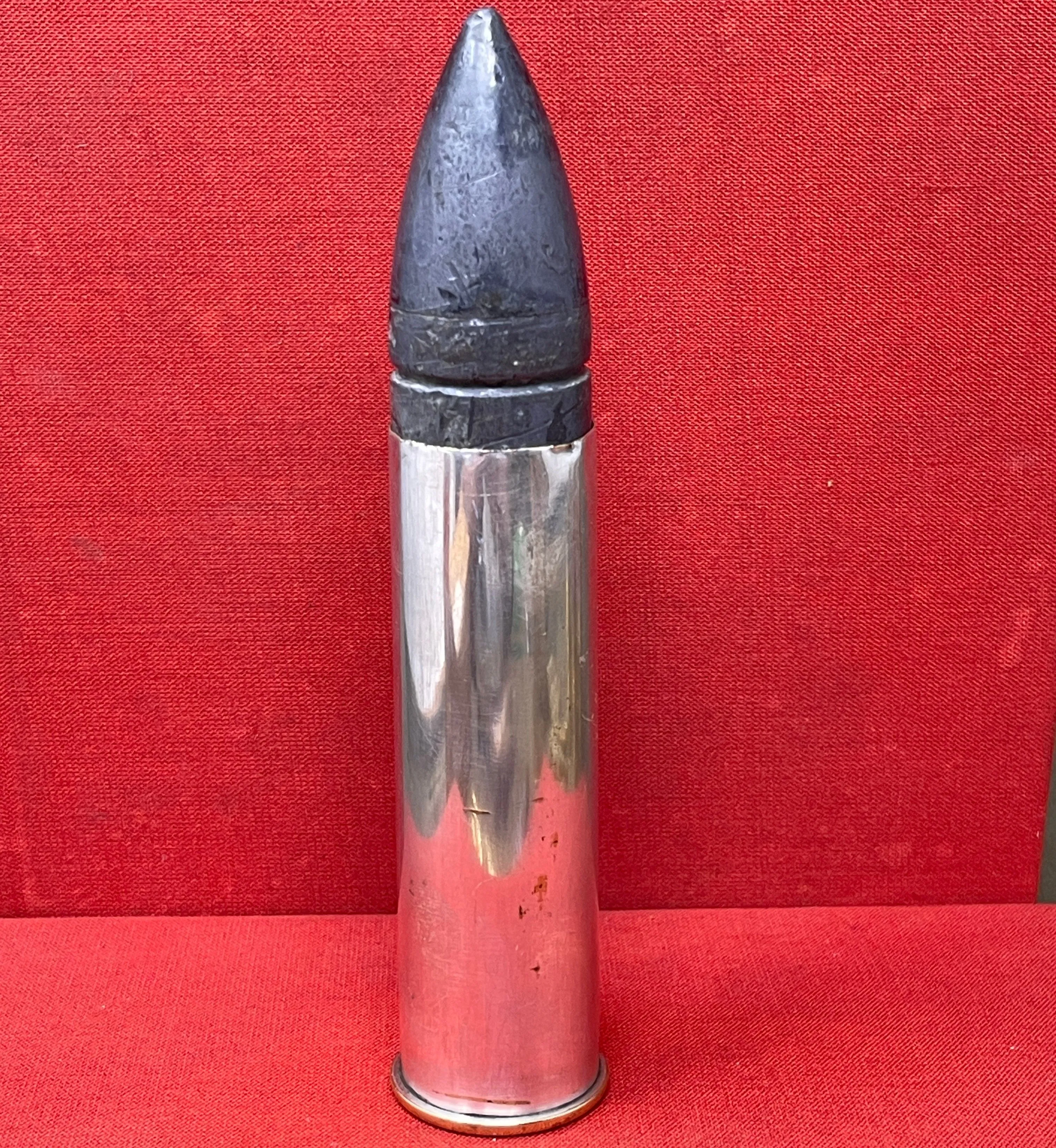 An Inert British Mark V M ( Morris) artillery 1" aiming rifle cartridge